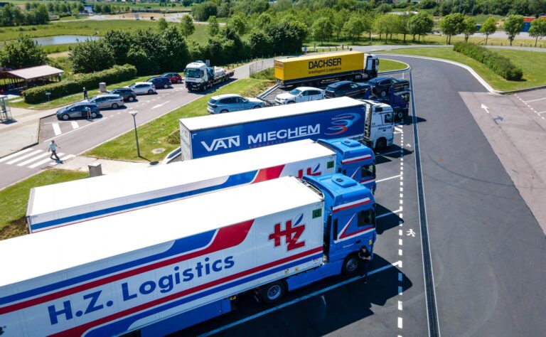 Aerial image showcasing logistics trucks parked in a rest area.